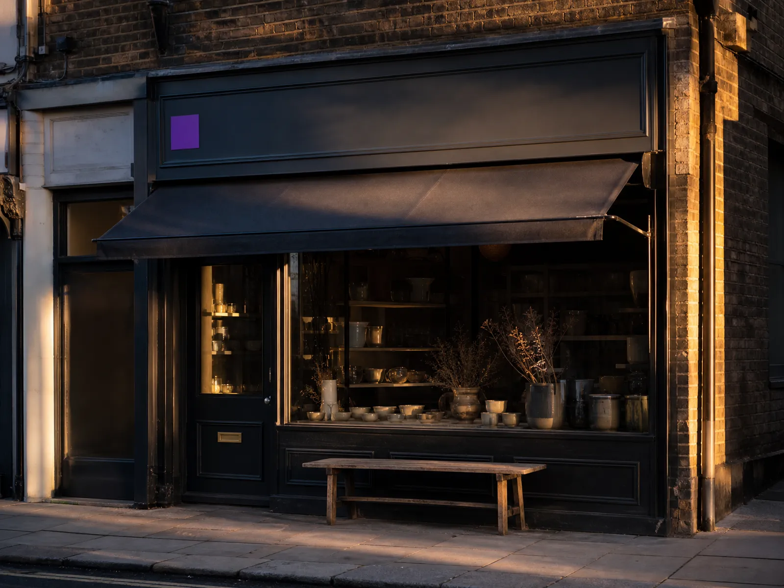 A UK high-street shopfront at golden hour with a subtle violet accent on the signage, showing local off-page SEO signals.