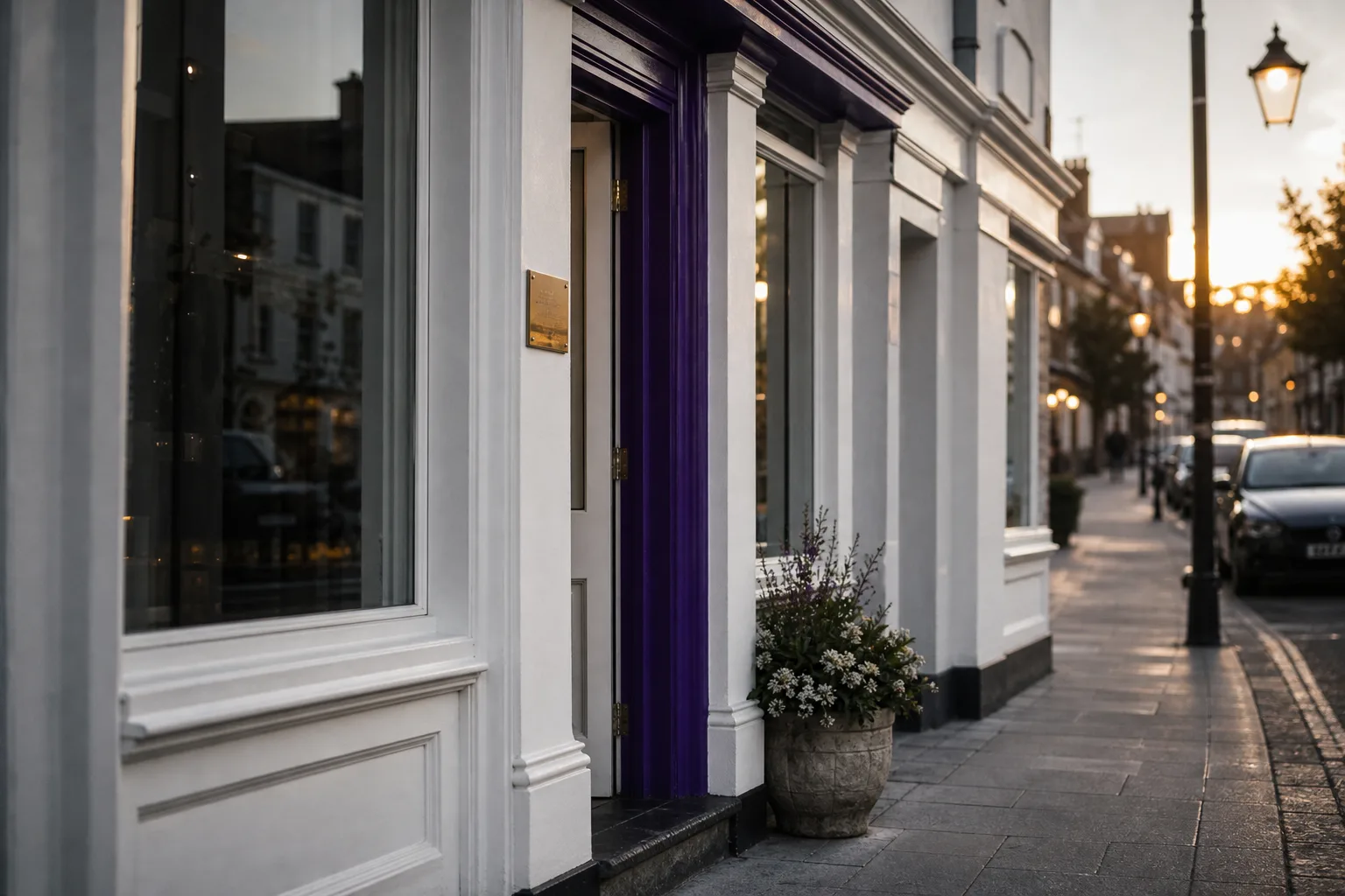 A small UK independent dental practice on a quiet high street at golden hour, illustrating SEO for dentists in the UK.