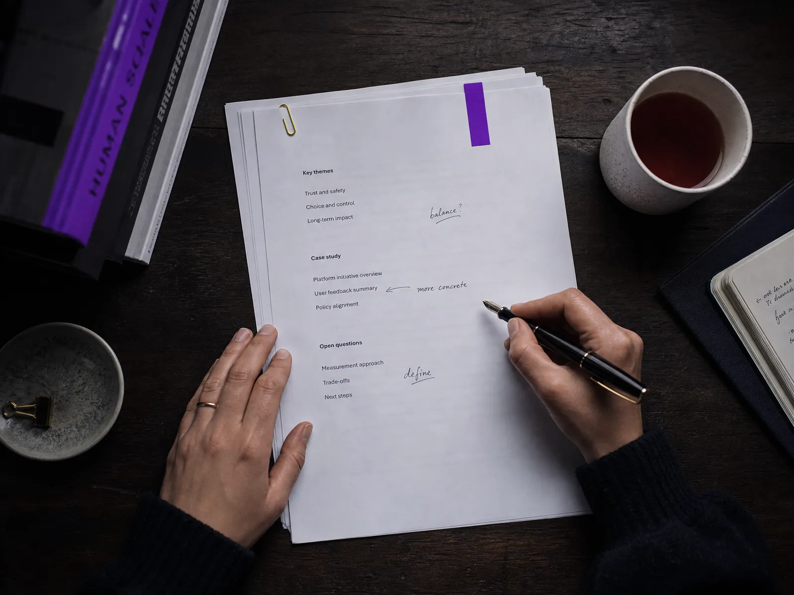 A printed page outline being annotated with a fountain pen, showing why each SEO page should have one clear job.