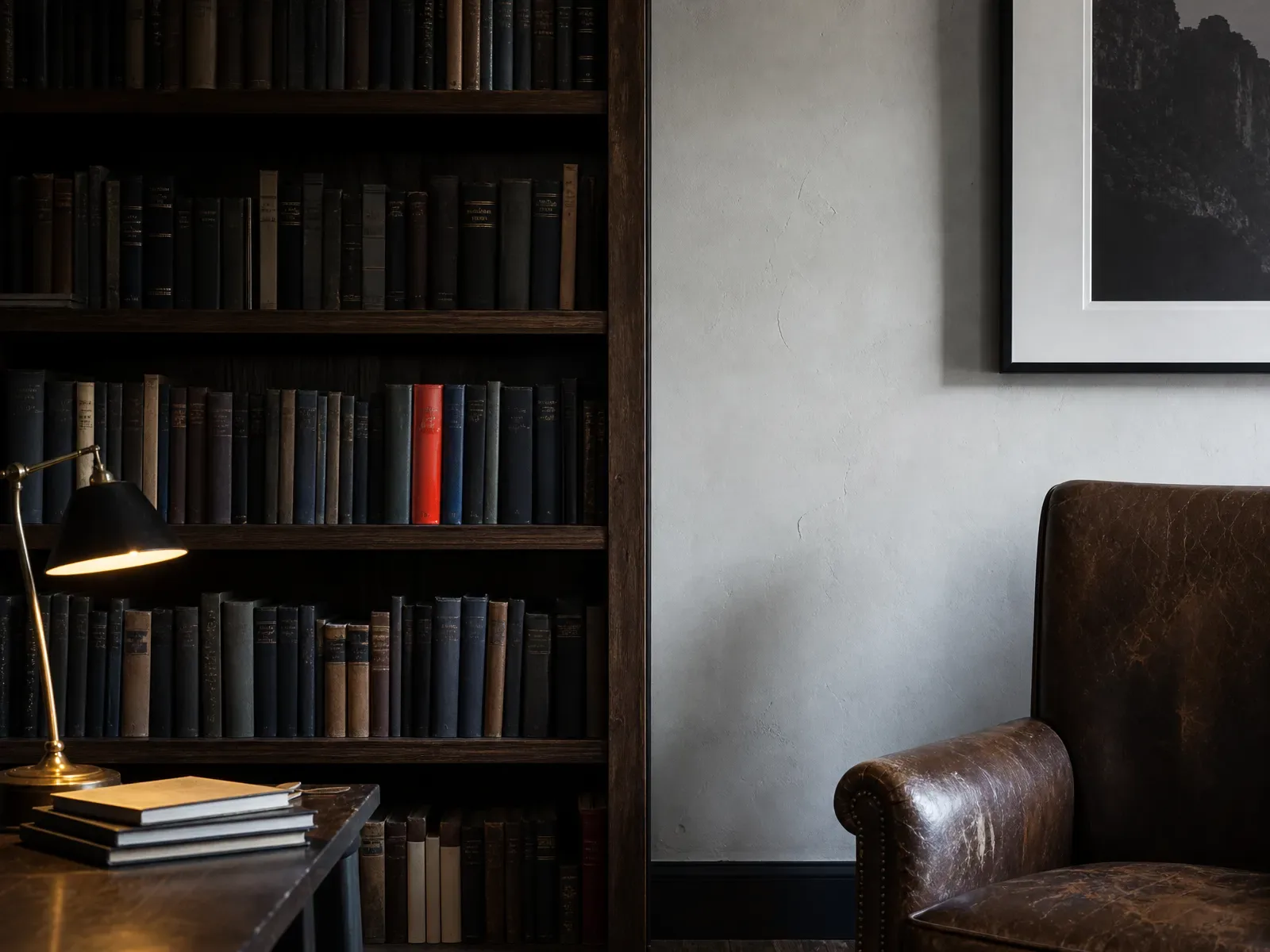 Quiet study corner with a wooden bookshelf, one red book spine at eye level and
